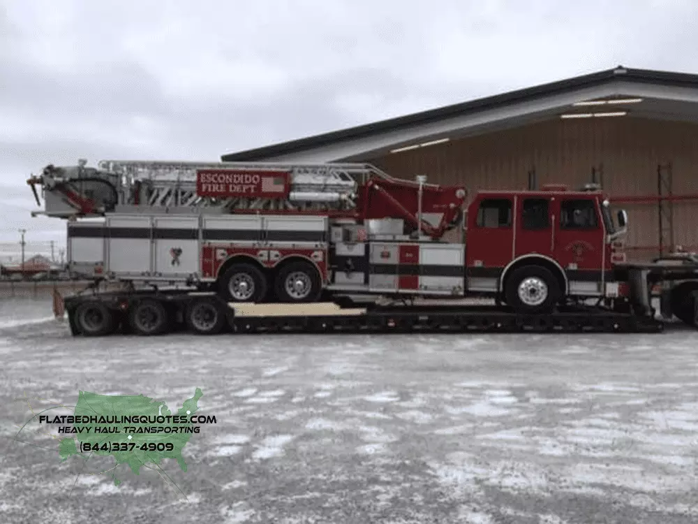 moving fire trucks on a flatbed trailer