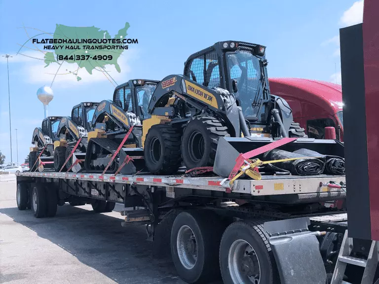 moving skid steers on a flatbed trailer